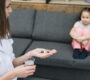 close up female doctor holding medicine glass water looking girl sitting sofa 90x80